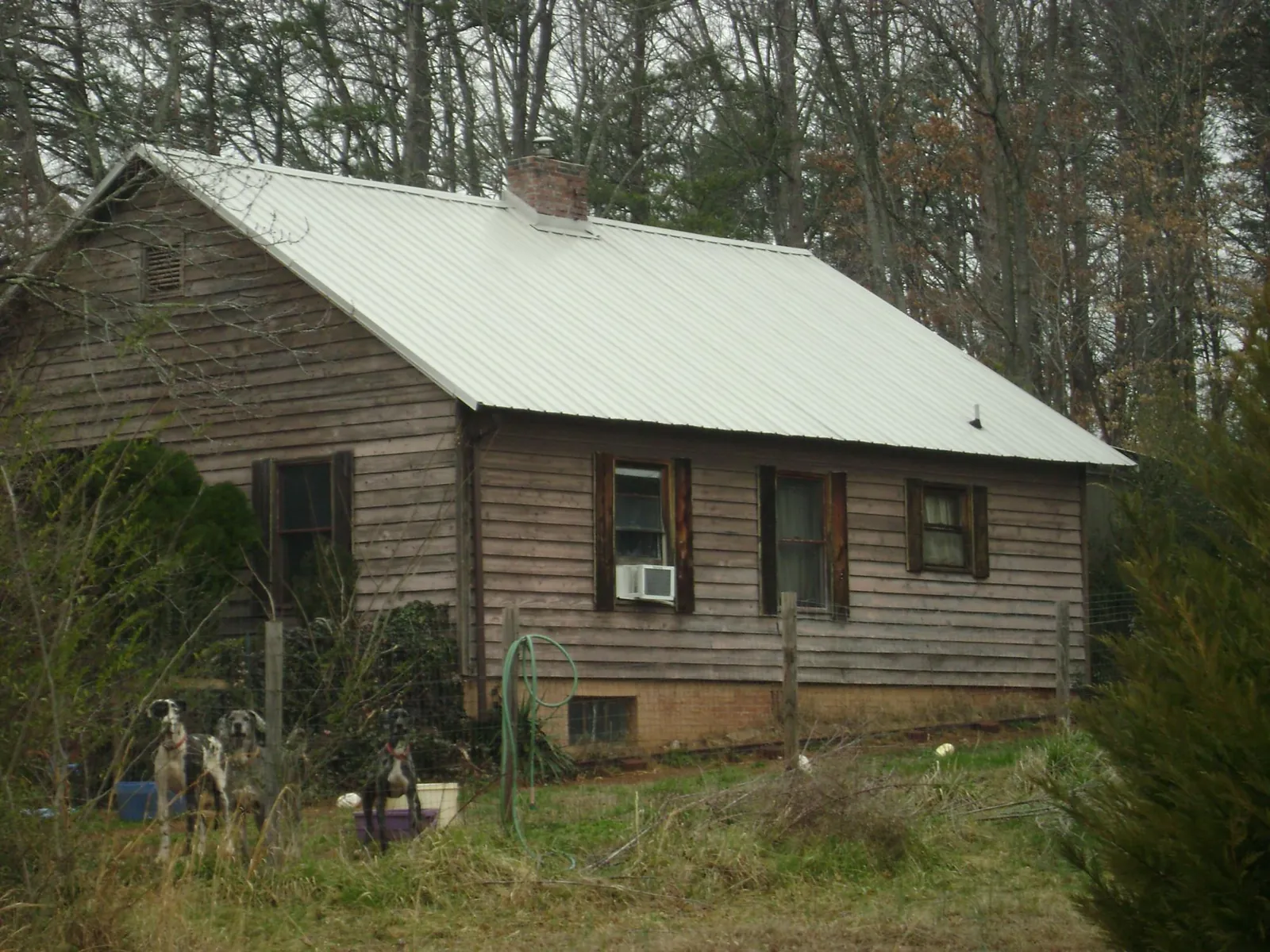 White metal roof on an old wood sided farmhouse, from a Metal Roof Installation job in Merrimac